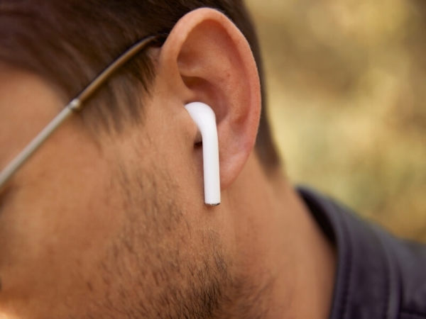 Muž s AirPods v uchu.